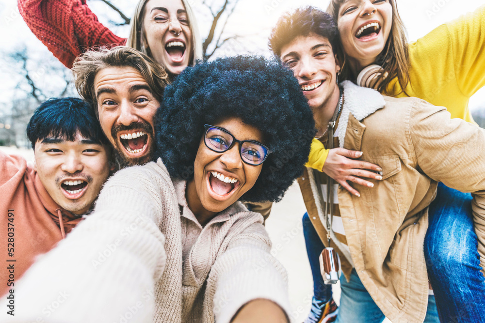 Multicultural friends taking selfie picture outside - Group of young people laughing at camera toget