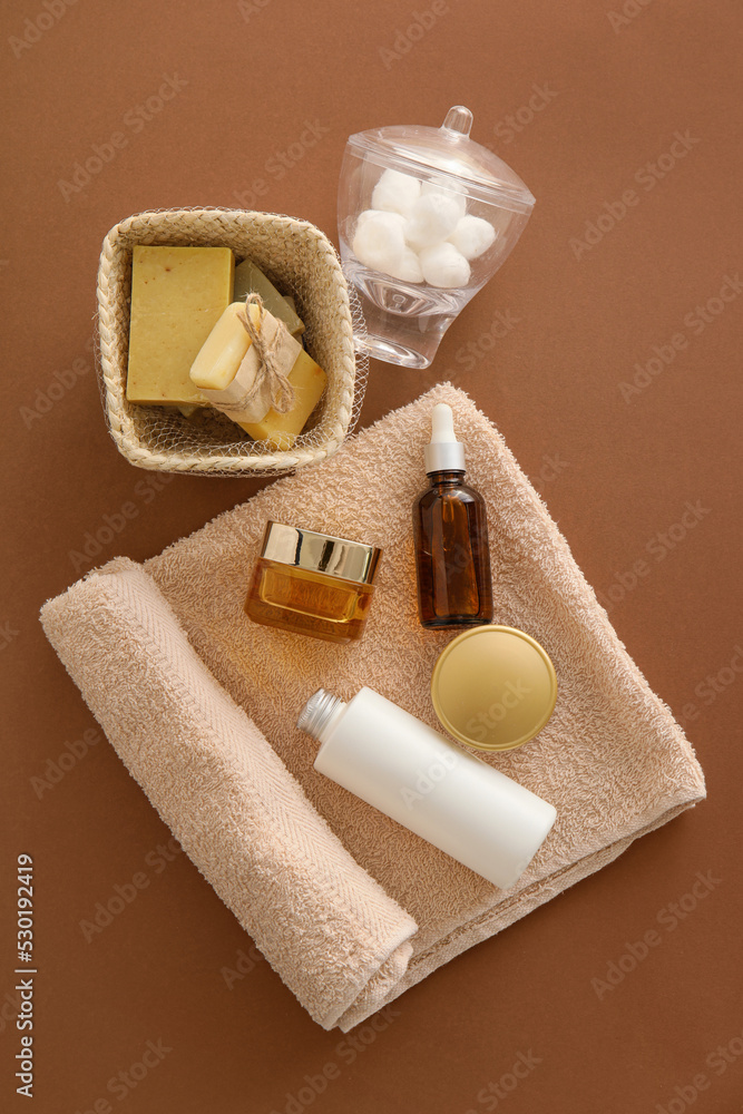 Composition with cosmetics and bath accessories on color background