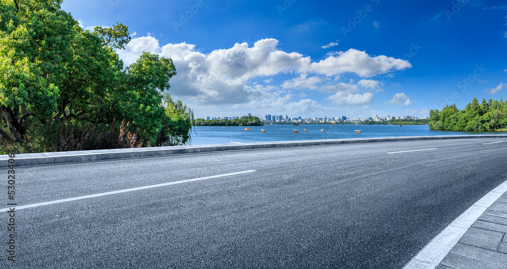 中国杭州，空旷的柏油路和城市天际线，现代建筑风光。