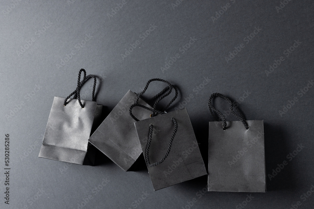 Composition of gray paper shopping bags on gray background