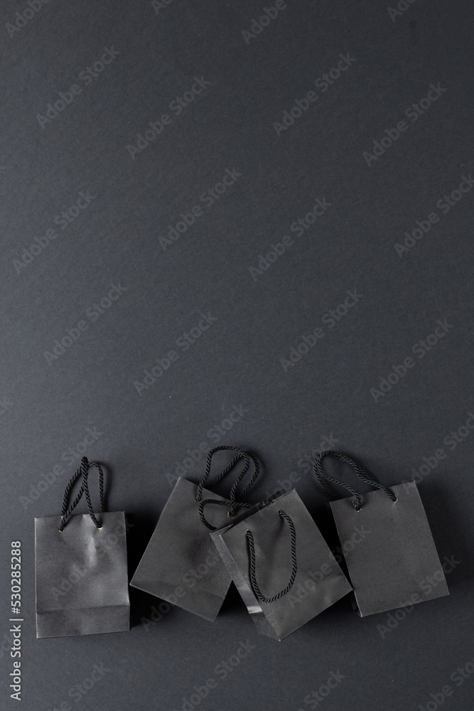 Composition of gray paper shopping bags on gray background