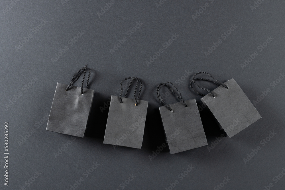 Composition of gray paper shopping bags on gray background