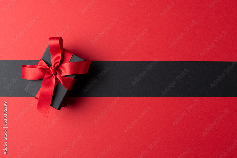 Composition of present with pink ribbon on gray and pink background