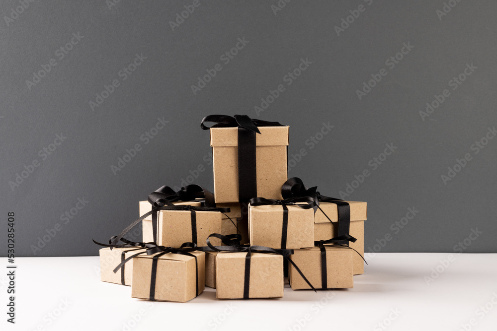 Composition of presents with black ribbons on gray background