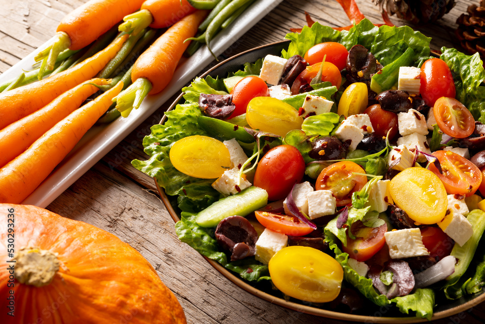 Close up of thanksgiving vegetables with autumn decoration on wood