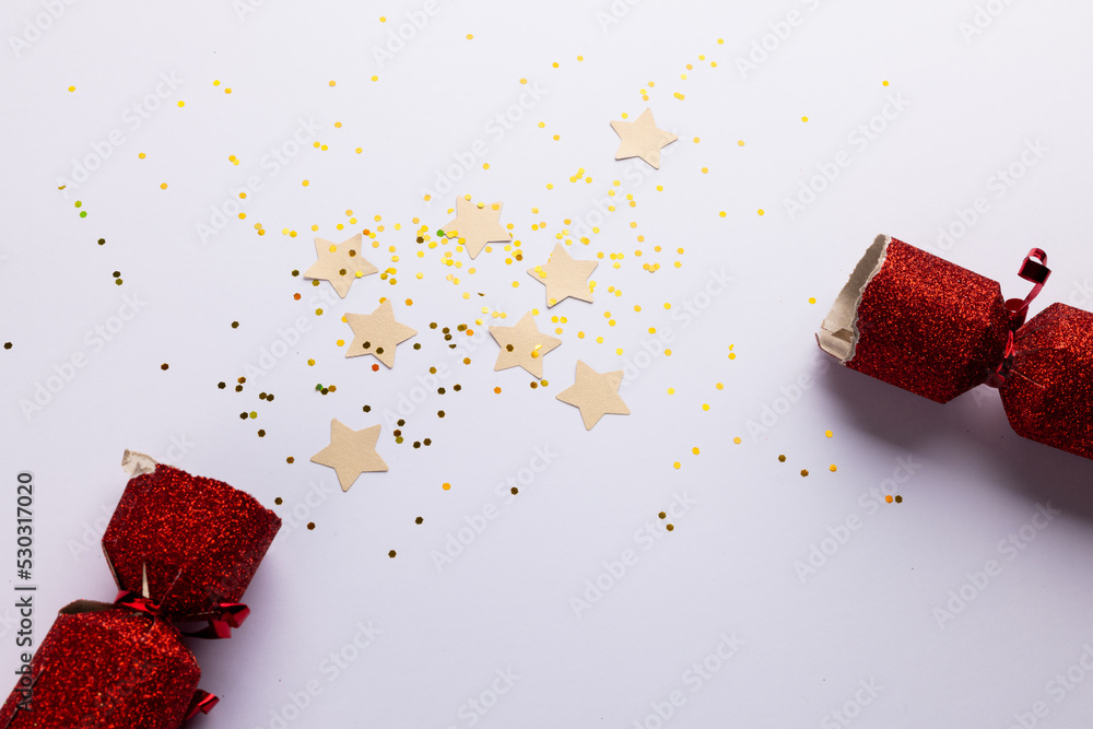 Image of christmas cracker with christmas decoration and copy space on white background