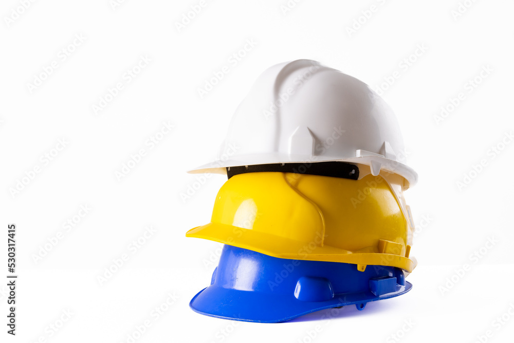 Image of stack of helmets lying on white surface