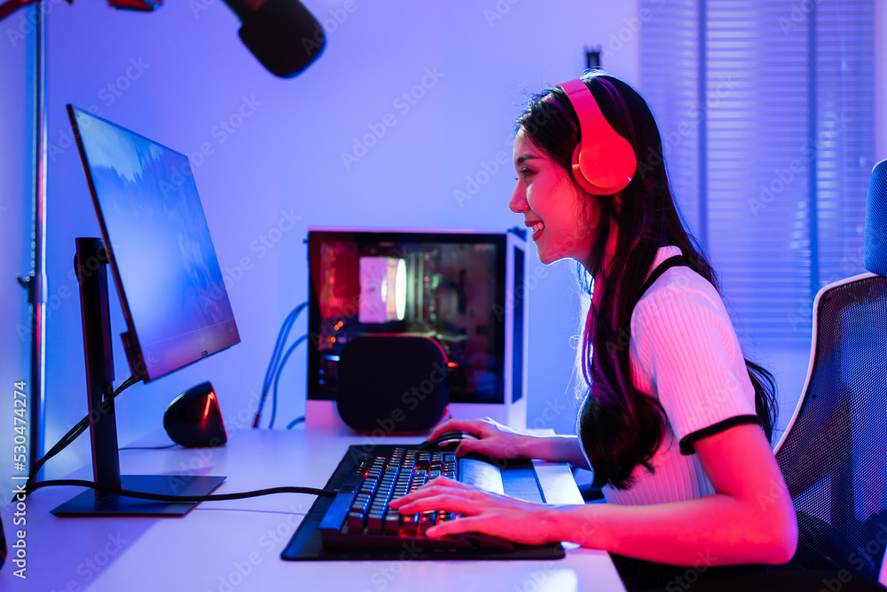 Asian beautiful Esport woman gamer play online video game on computer.