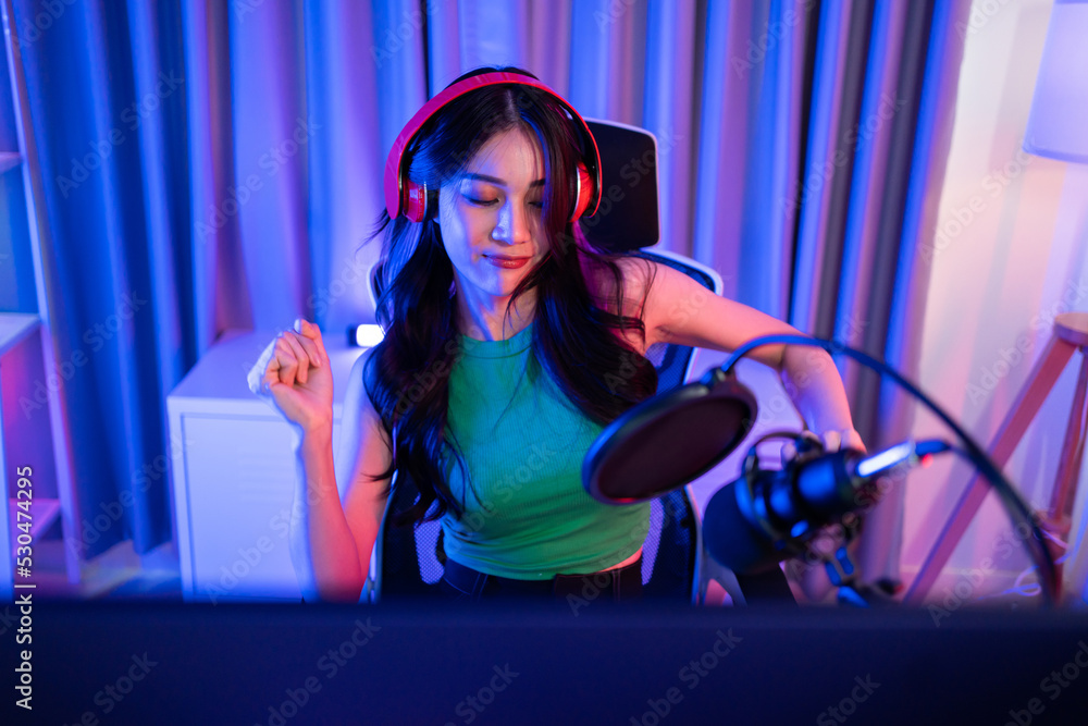 Asian young audio DJ woman sing a song on microphone to broadcasting