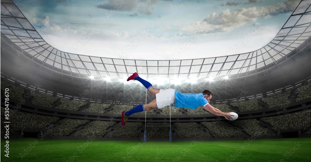 Composition of male rugby player diving holding ball on rugby pitch