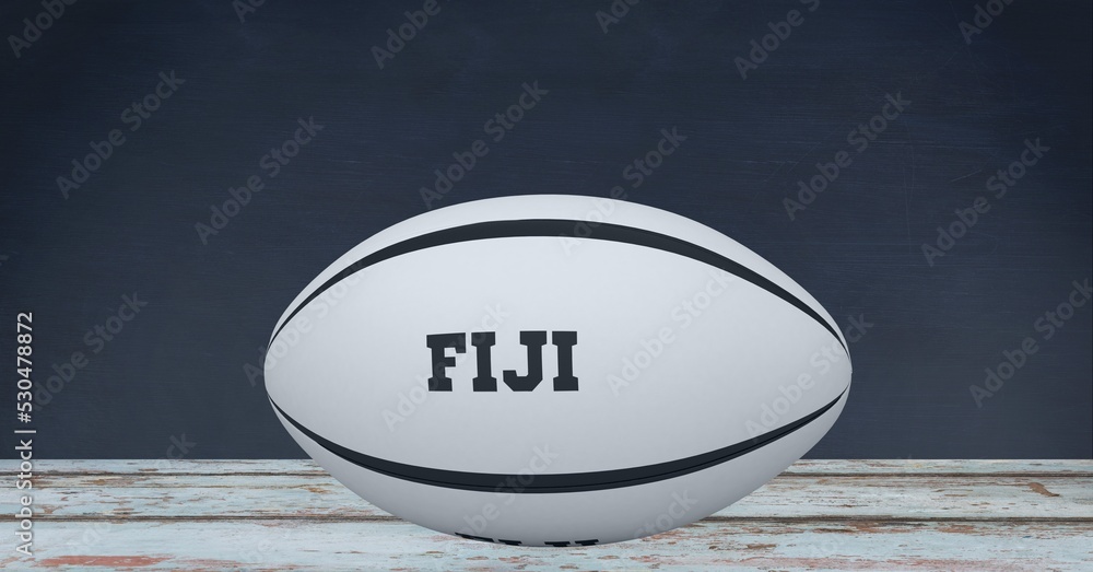 Composition of rugby ball decorated with text fiji on black background