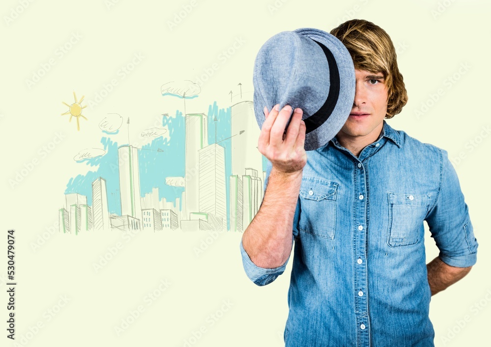 Caucasian man holding a hat in front of his face against cityscape painting with copy space