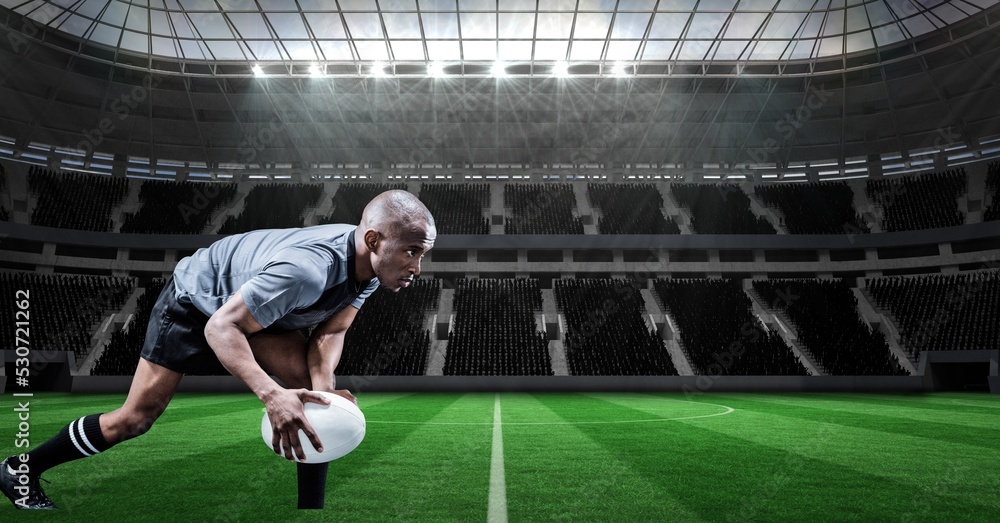 Composition of male rugby player holding rugby ball over sports stadium