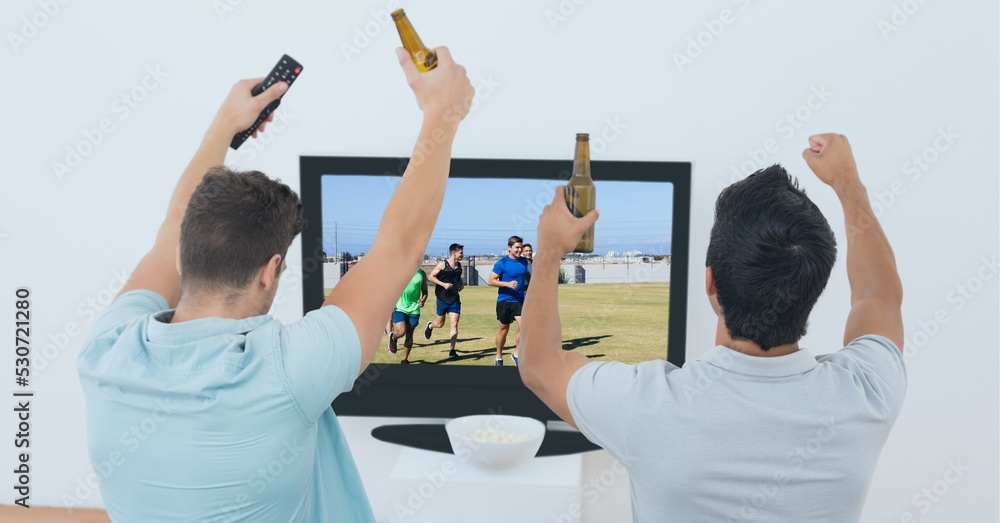 Composition of two male sports fans watching football match on tv