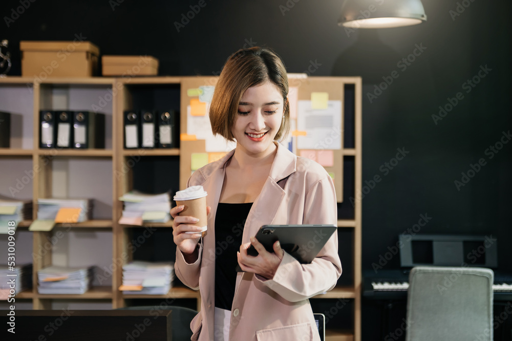  Working woman concept a female manager attending video conference and holding tablet, smatrphone an