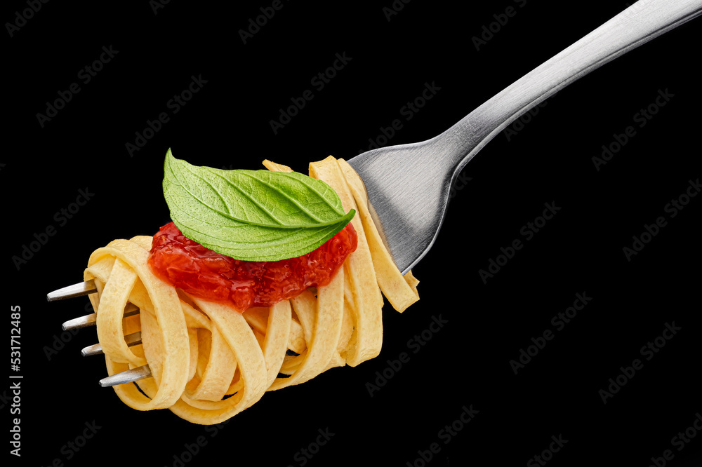 Italian spaghetti on fork on black background