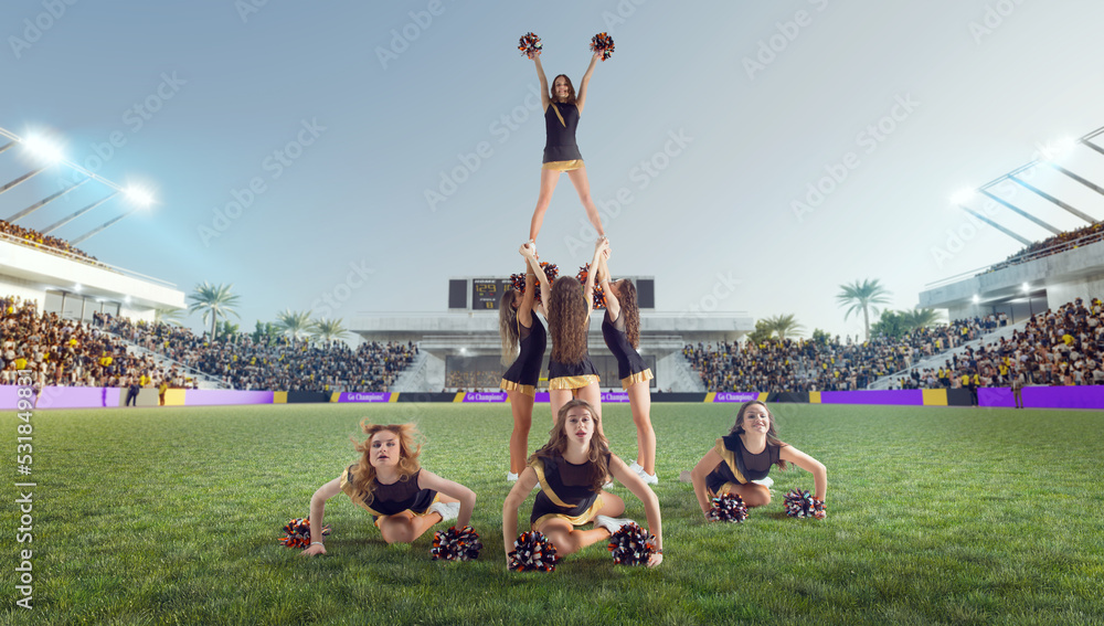 Group of cheerleaders in action on  stadium