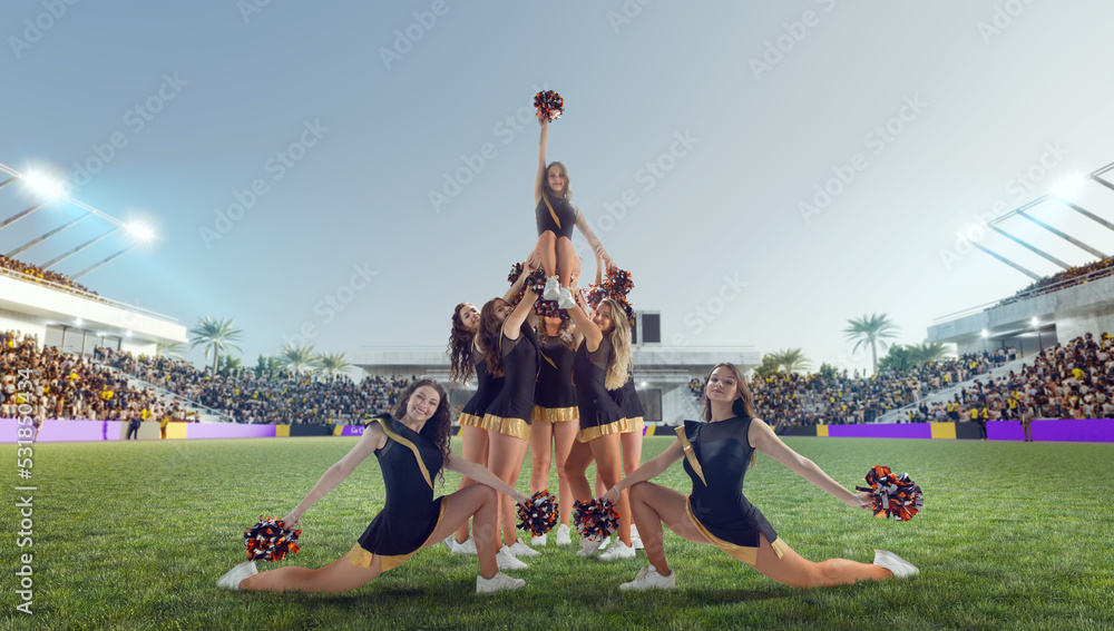 Group of cheerleaders in action on  stadium