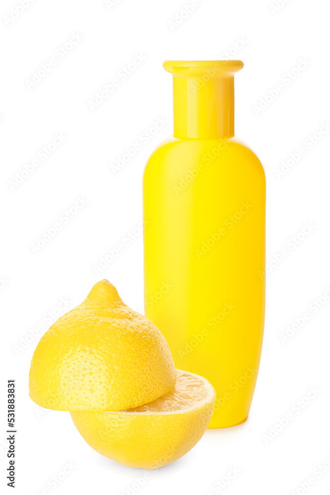 Bottle of shampoo and lemon on white background