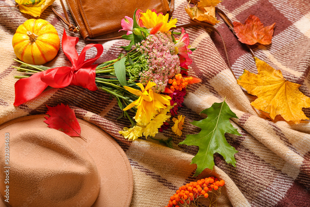 Stylish female accessories, bouquet of flowers and autumn decor on soft plaid, closeup