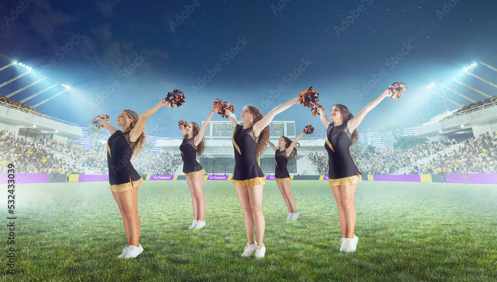 Group of cheerleaders in action on  stadium in night