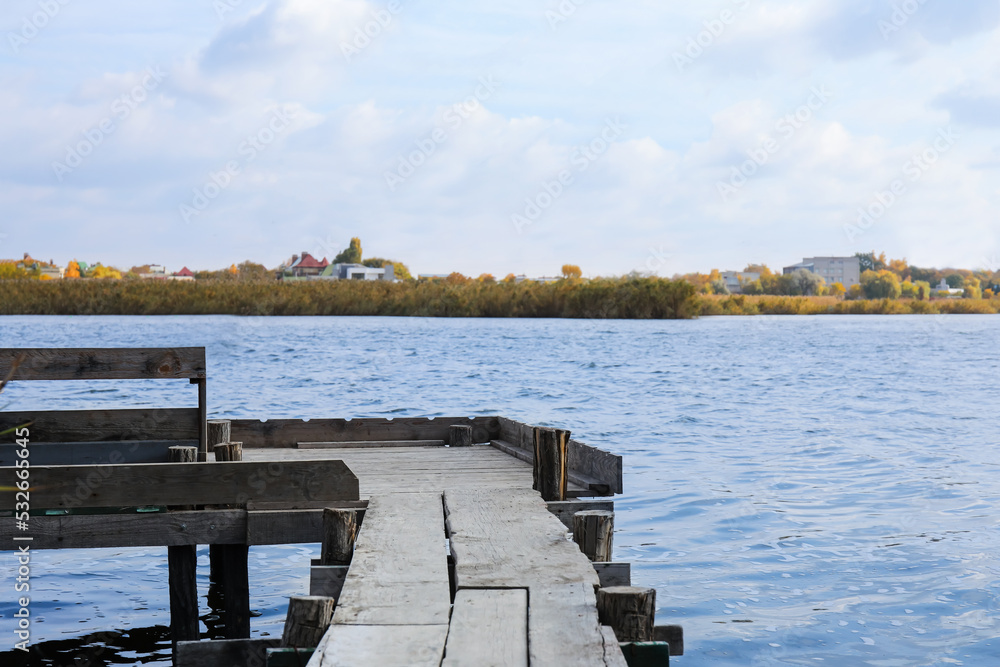 Wooden pier near river on warm day