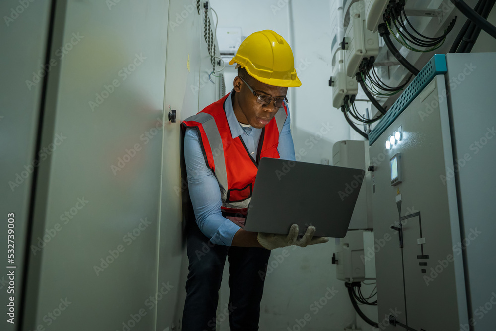 Engineer working in electrical control room,operator station network in industry factory,Switchgear.