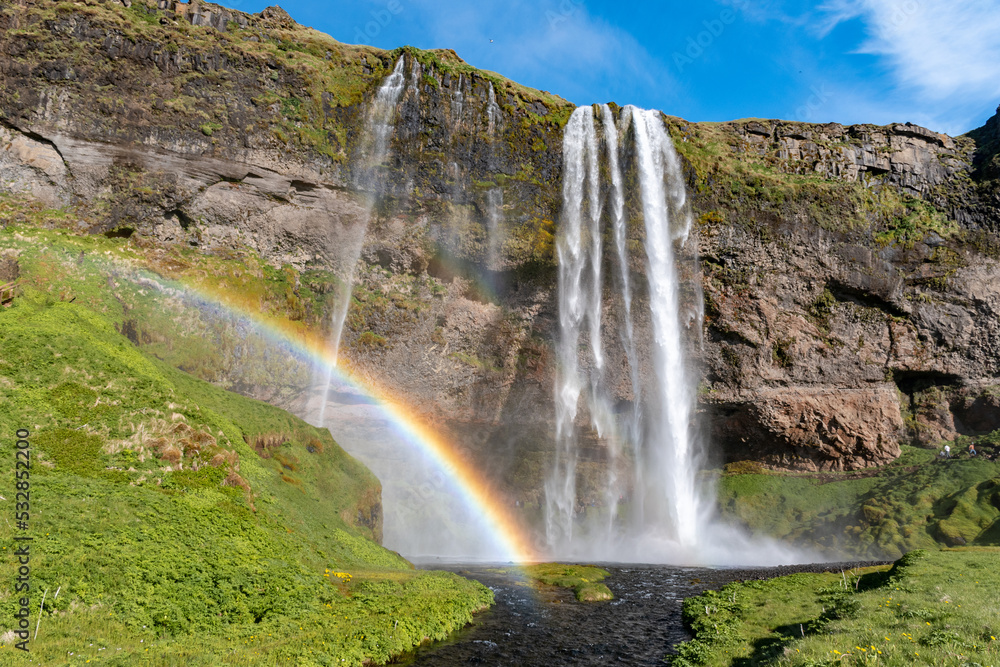 The waterfall Seljalandsfoss with a rainbow, famous landmark in southern Iceland