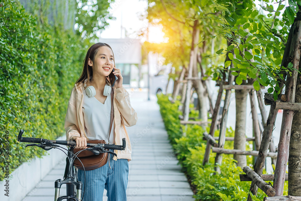 Beautiful Asian woman listening favourite music on headphones from mobile phone, Happiness relaxatio