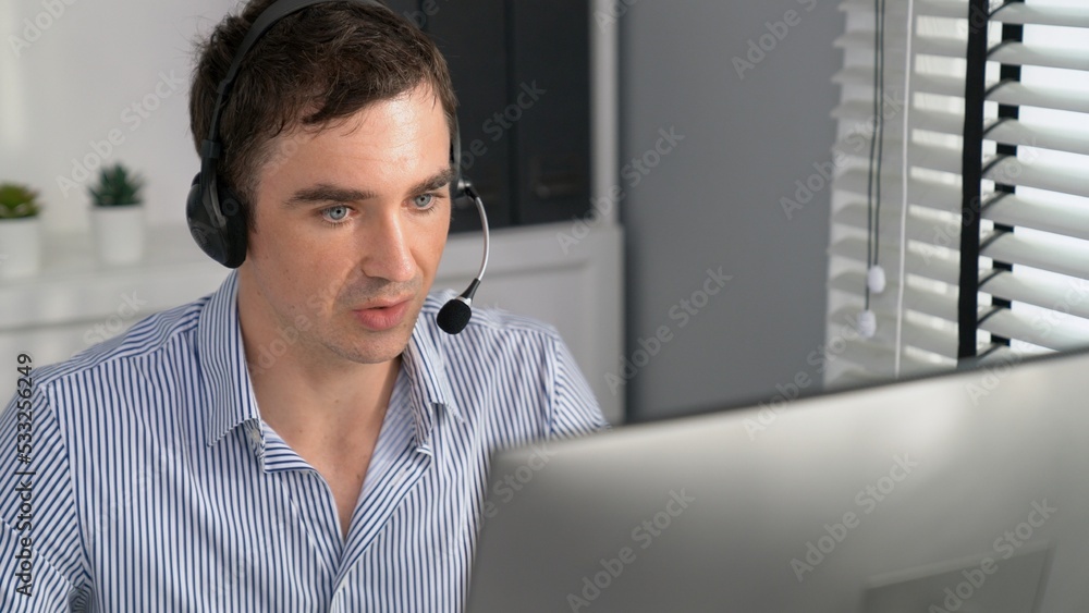 Competent male operator working with customers in the office. Concept of an operator, customer servi