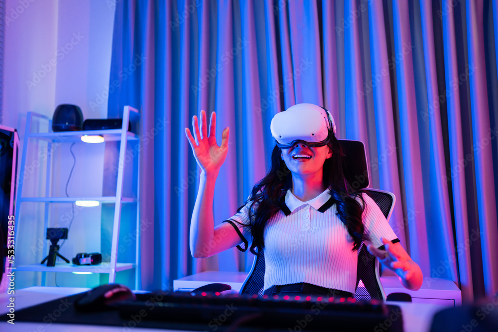 Asian young esport woman gamer use technology VR glasses and play game