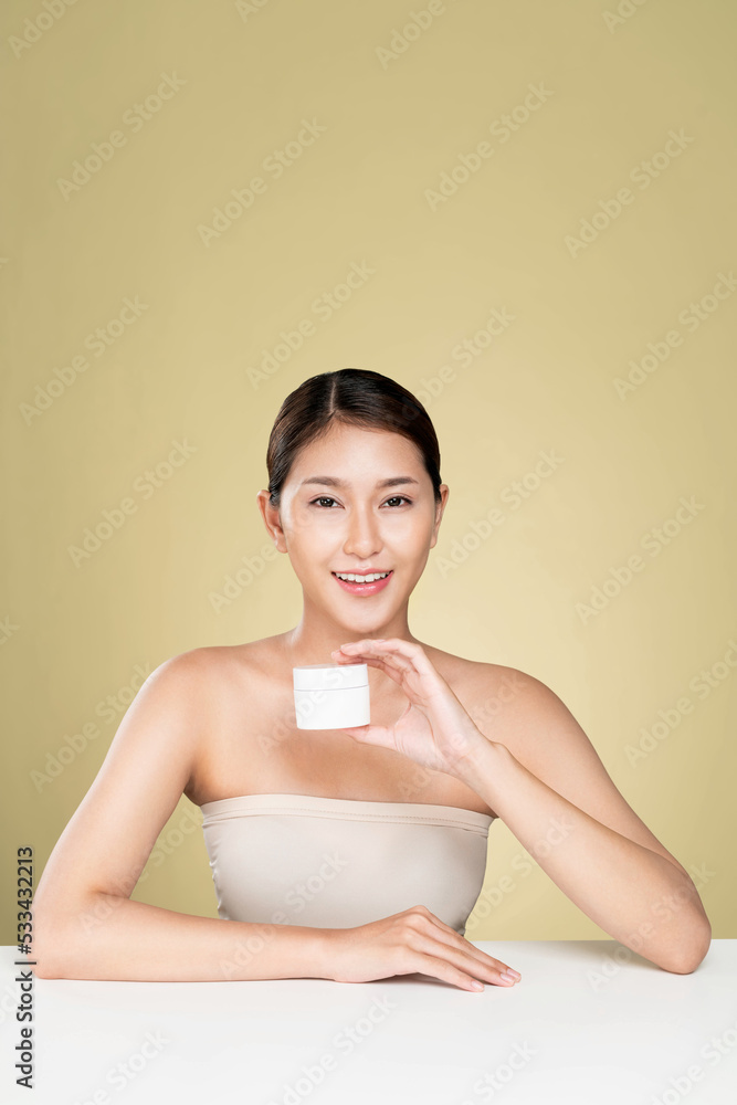 Ardent woman smiling holding mockup product for advertising text place, light grey background. Conce