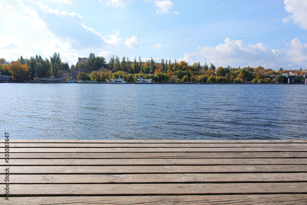 Closeup view of wooden pier near water in city