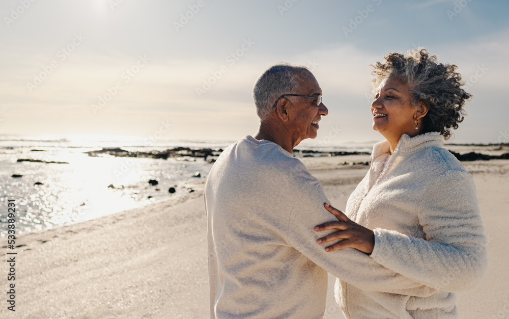 Mature couple dancing together at the beach