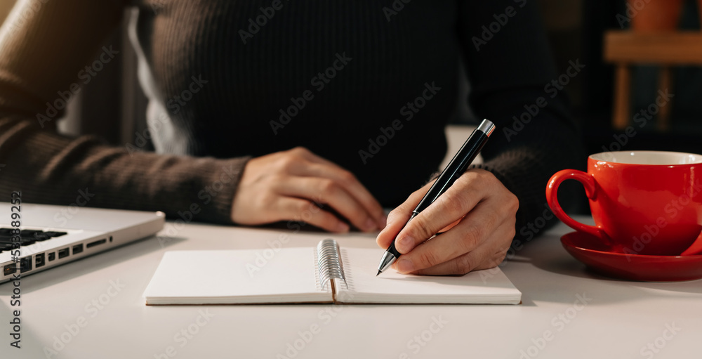 businesswoman hand working with new modern computer and writing on the notepad strategy diagram as c