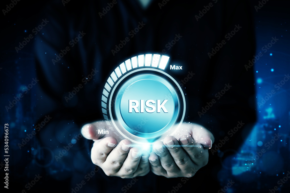 Risk management business strategy planning concept. Businessman hand holding risk level