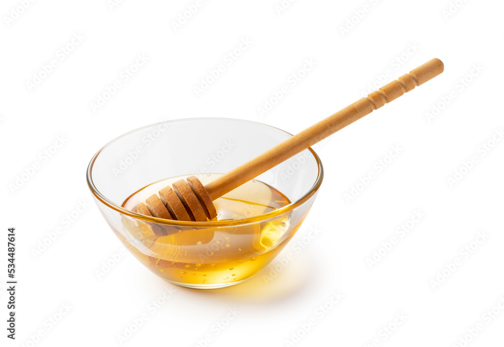 Honey and honey dippers in glass bowls on white background.