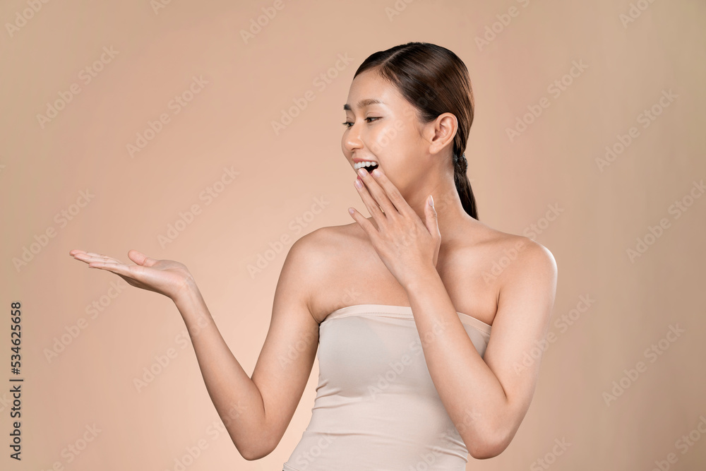 Portrait of ardent woman looking at camera, holding empty space for product, advertising text place,