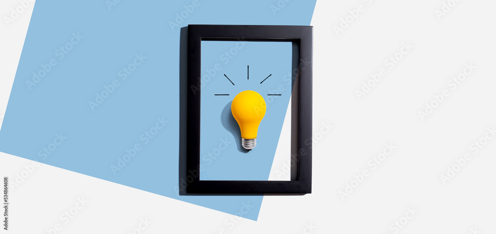 Yellow light bulb inside a frame - inspiration, creativity themes