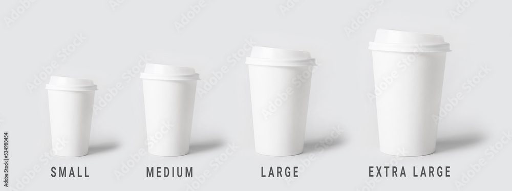 Different sized takeaway coffee cups on light background