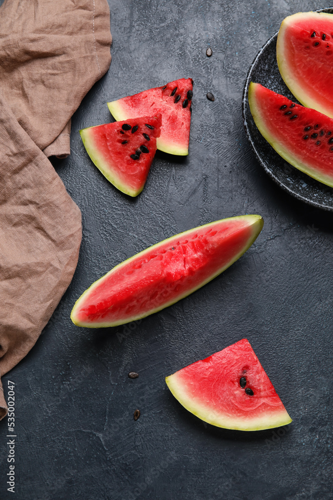 Slices of watermelon and napkin on dark background