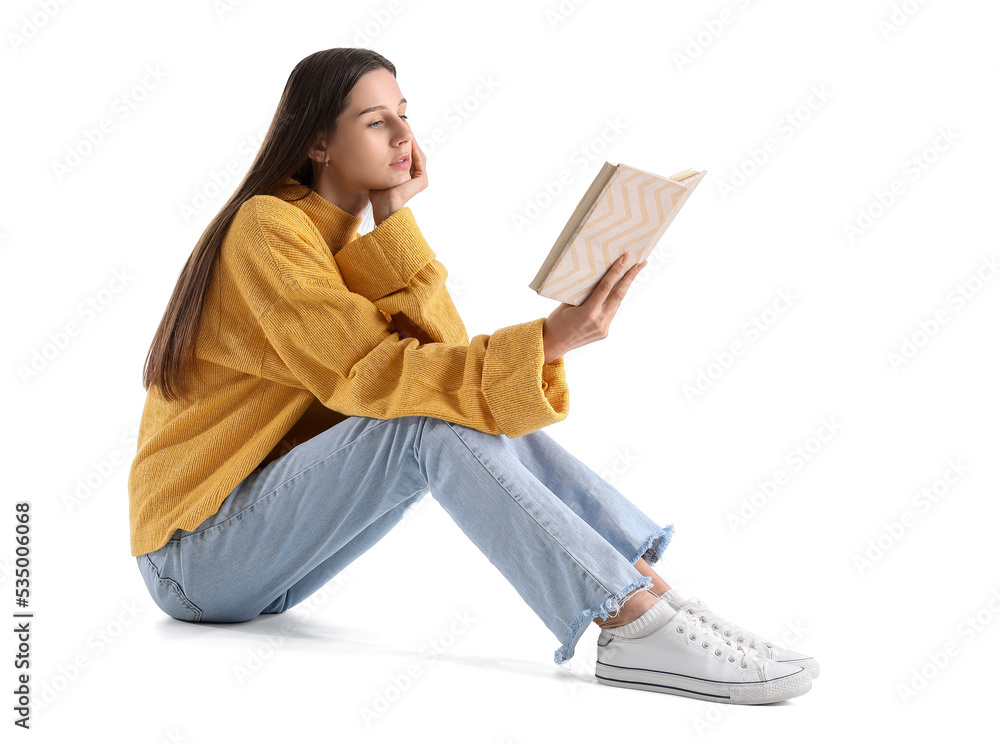 Beautiful woman in yellow sweater reading book on white background