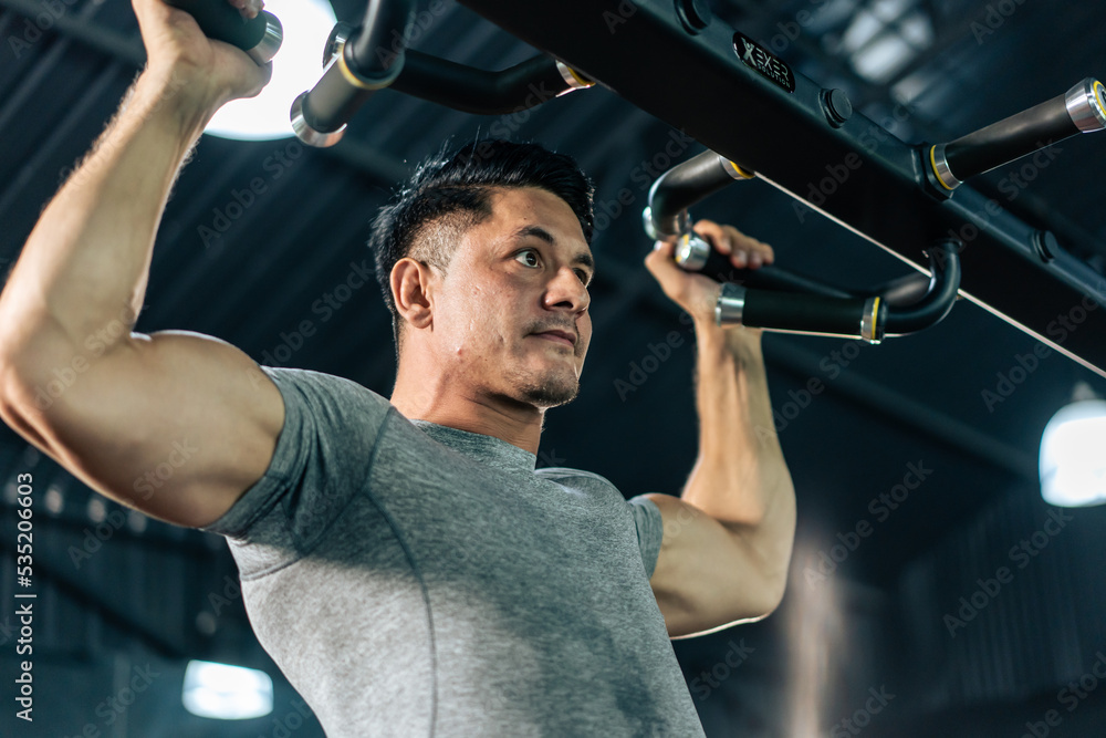 Caucasian sportsman slowly lift up weight machine barbell in stadium.