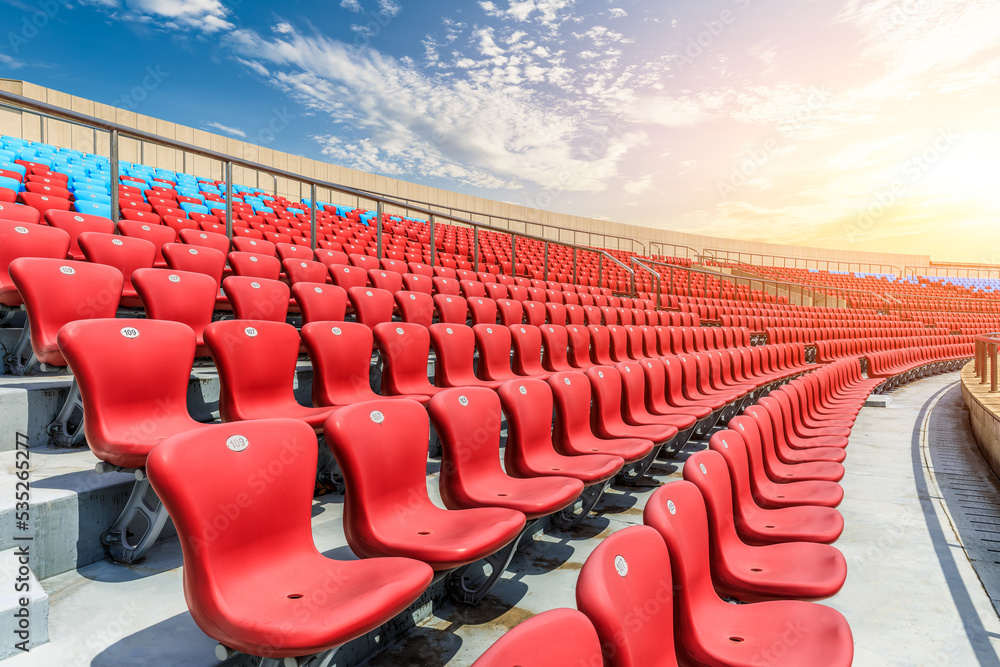 Red seats and beautiful sky clouds in the stadium