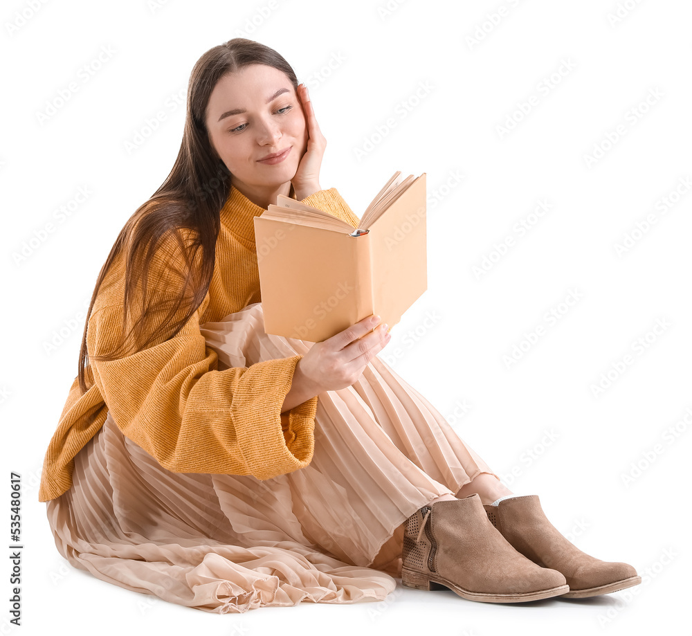 Beautiful woman in yellow sweater reading book on white background