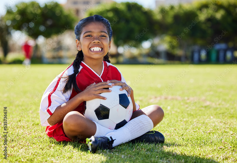 Sports, children and girl soccer player relax on grass with soccer ball, happy and excited at traini