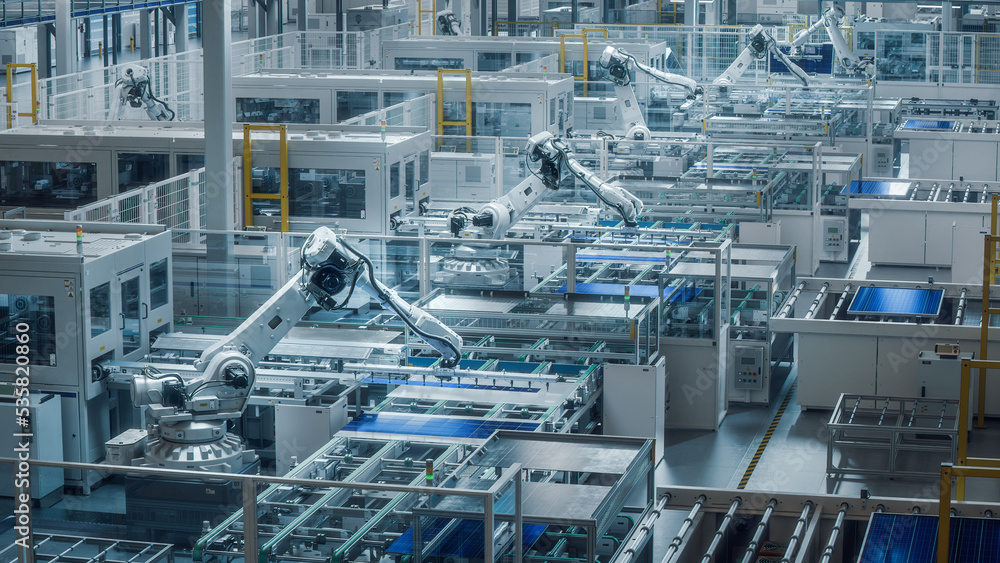 Large Production Line with White Industrial Robot Arms at Modern Bright Factory. Solar Panels are be