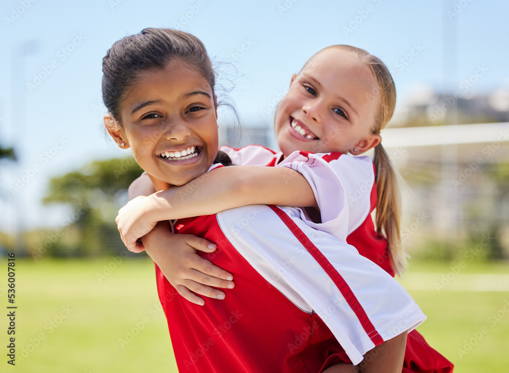 Team, sport and soccer player girl children with a happy smile having fun on a outdoor football fiel