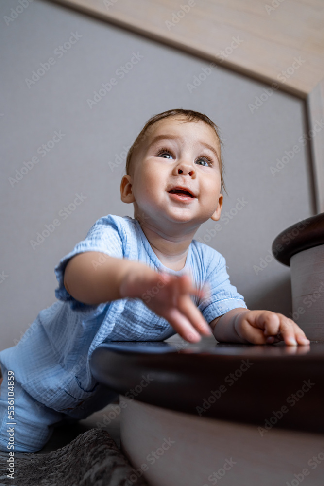 Adorable cute child having fun. Little cute kid playing with ball on the floor.