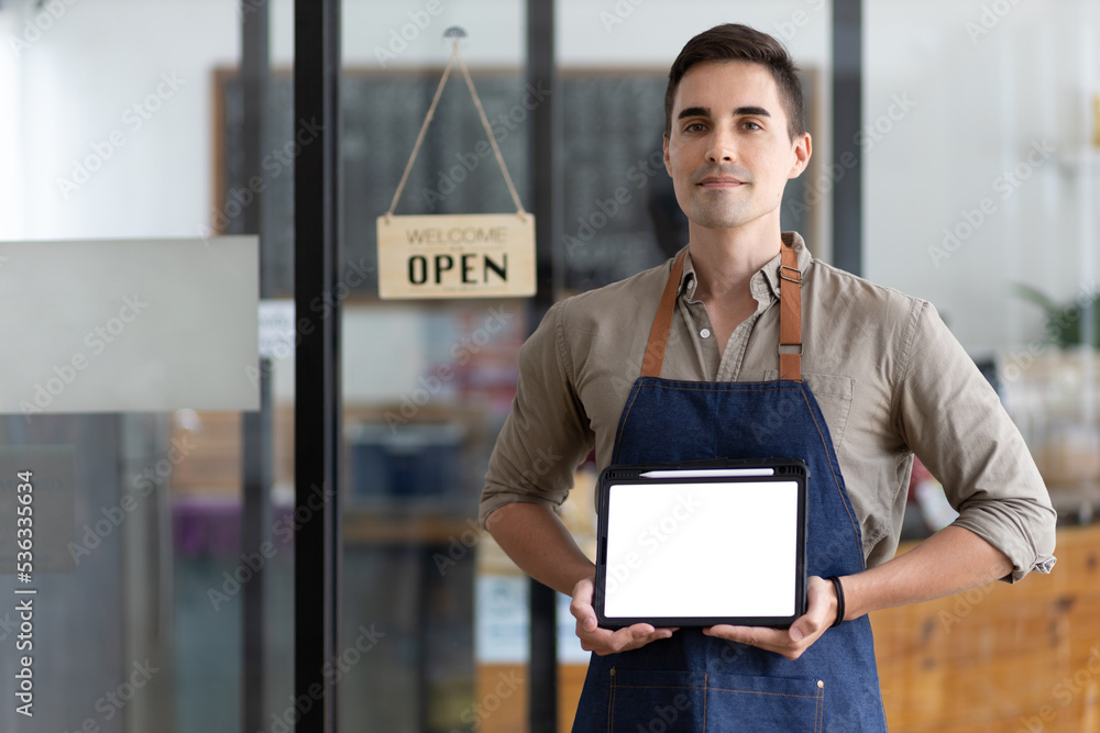 Portrait of a handsome young waitress holding a digital tablet showing food and beverages in a resta